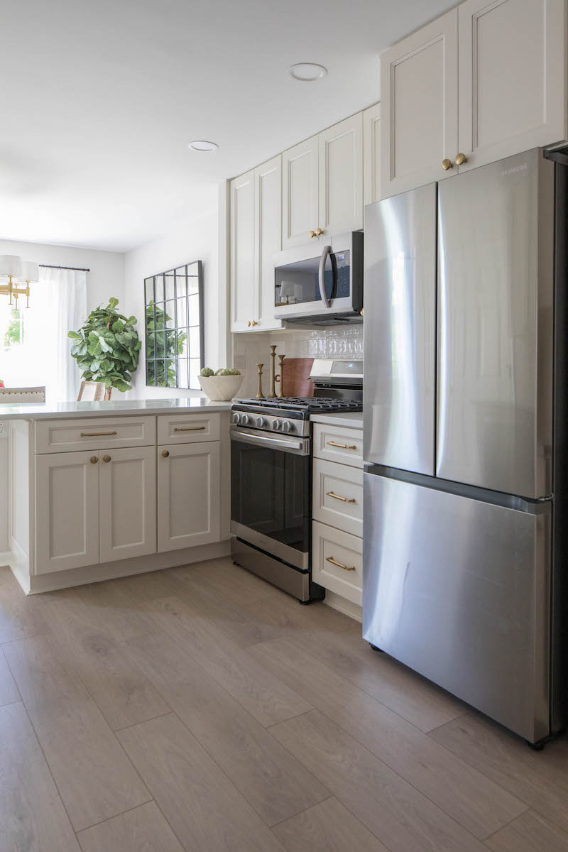 Apartment kitchen with white cabinets and stainless steel appliances