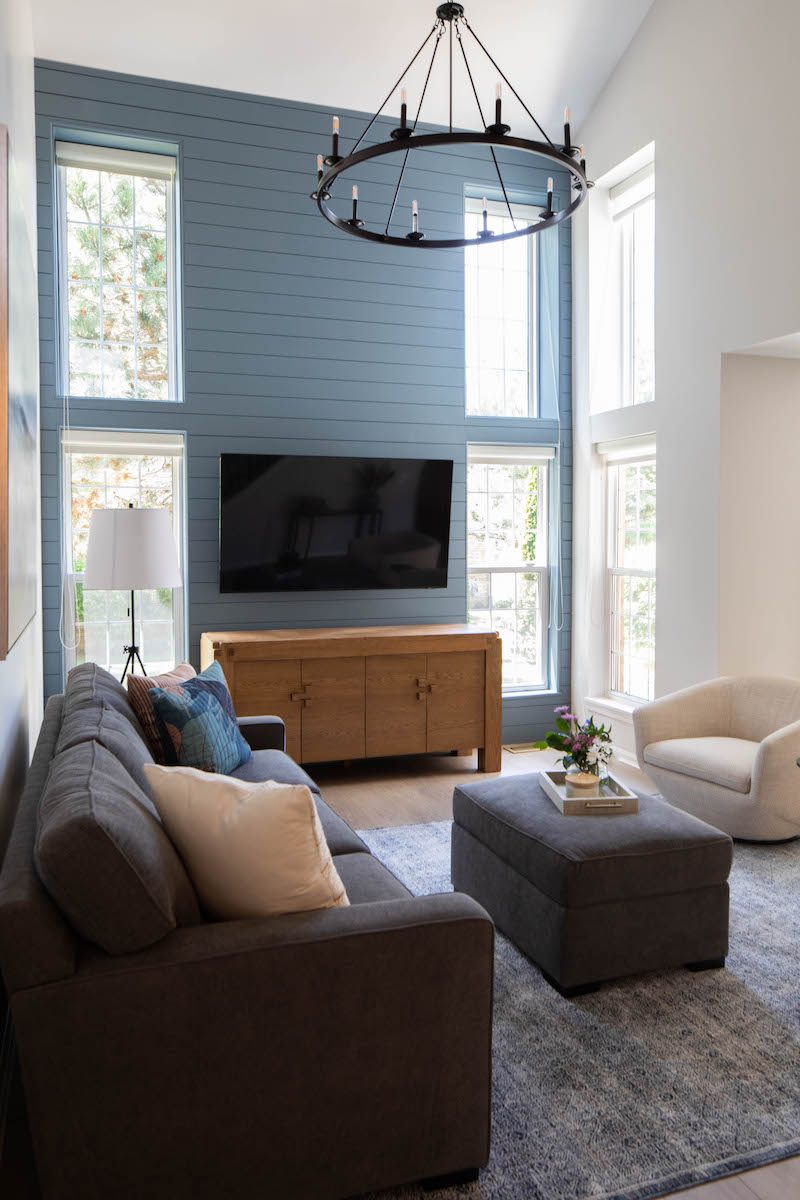 Townhouse living room with blue walls and large windows