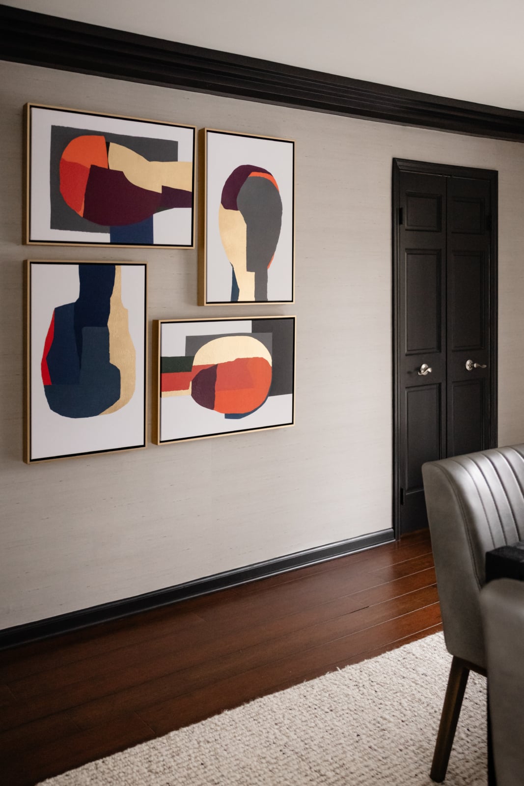 Abstract art panels above a dark wood floor in an Oak Brook, IL dining room by Dara Agruss Design