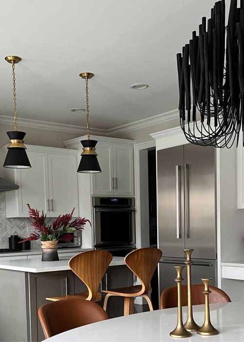 Traditional kitchen with white cabinets and black accents designed by Dara Agruss Design