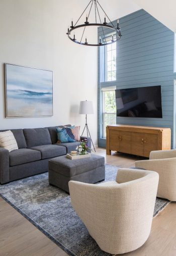 Townhouse living room with gray sofa and textured rug