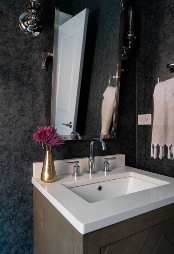 Close-up of white sink with silver faucet on washroom