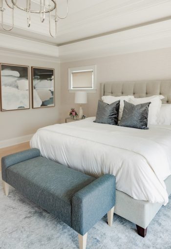 Neutral bedroom with cushioned headboard and beige walls