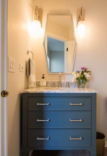 Washroom sink with blue cabinets