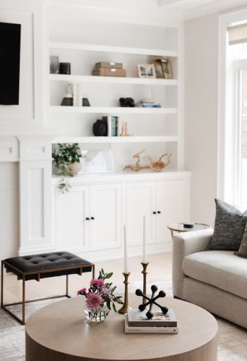Living room with white bookshelf and round coffee table